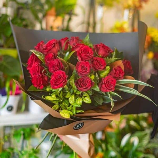 Beautiful red rose bouquet in modern flower shop, fresh floral arrangement, floral shop delivery, Simply Blooming NZ.