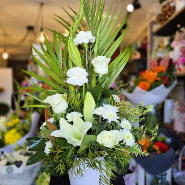 Lush white floral arrangement in a Simply Blooming vase, perfect for special occasions and gift-giving.