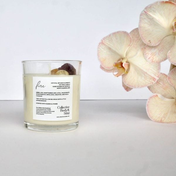 Elegant candle with crystal elements, orchid flowers for home fragrance and natural decor.