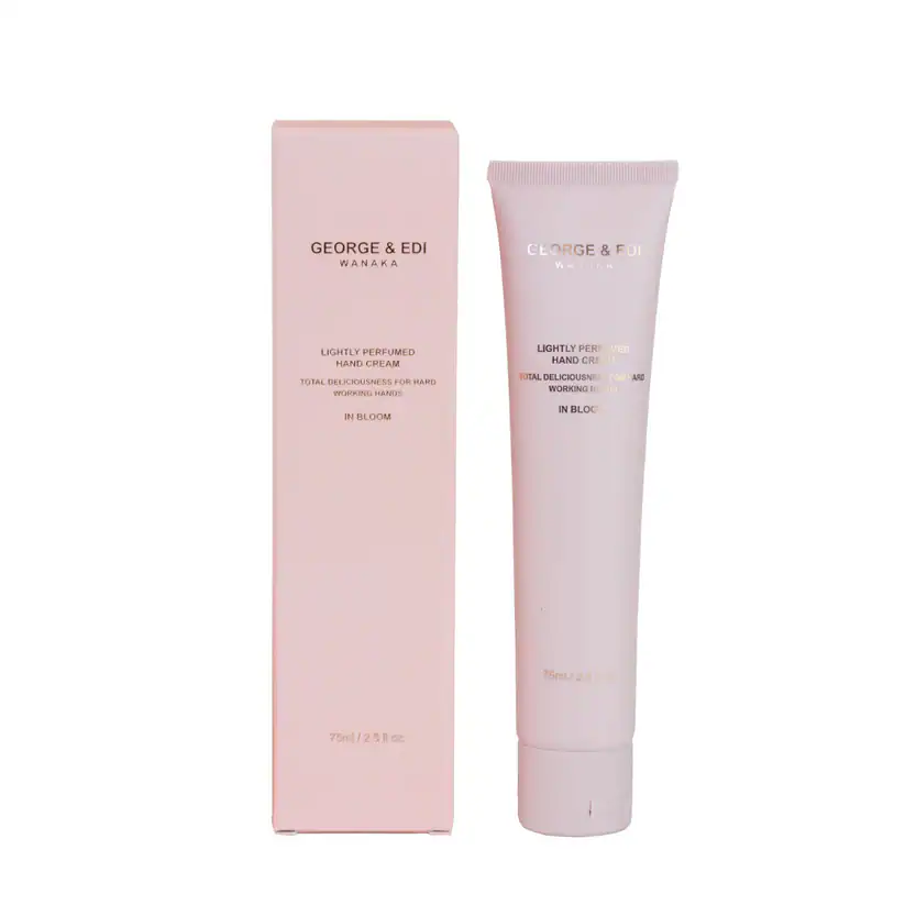 Gentle pink hand cream in a tube with floral packaging for soft, hydrated hands.