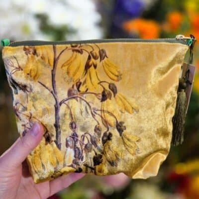 Handmade botanical print zippered pouch featuring yellow flower illustrations, perfect for gardening and floral enthusiasts.