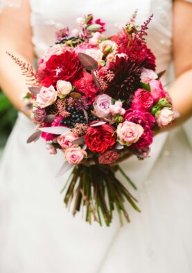 Pink and red bridal bouquet Bouquet of pink and deep red roses, dahlias, and berries for a wedding or special occasion.