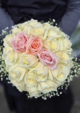 20251031_151744 Bouquet of fresh cream and pink roses with baby's breath, perfect for weddings or special occasions.