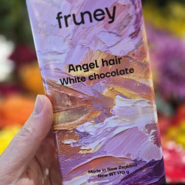 Delicate white chocolate with angel hair texture, presented in a pastel abstract wrapper.