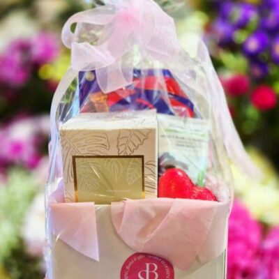 Beautifully wrapped floral gift box with chocolates and treats, perfect for special occasions.
