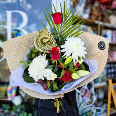 Beautiful bouquet featuring red roses, white lilies, and greenery, perfect for celebrations or gifti.