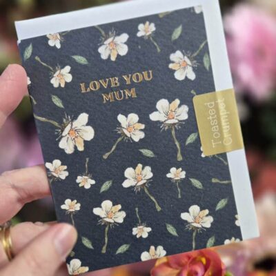 Love You Mum greeting card with floral design and gold lettering.