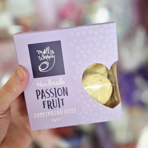 Delicious handmade passion fruit shortbread bites in a purple box, perfect for gifting or enjoying as a sweet treat.