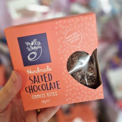 Salted chocolate cookie bites in a pink box with a clear window.