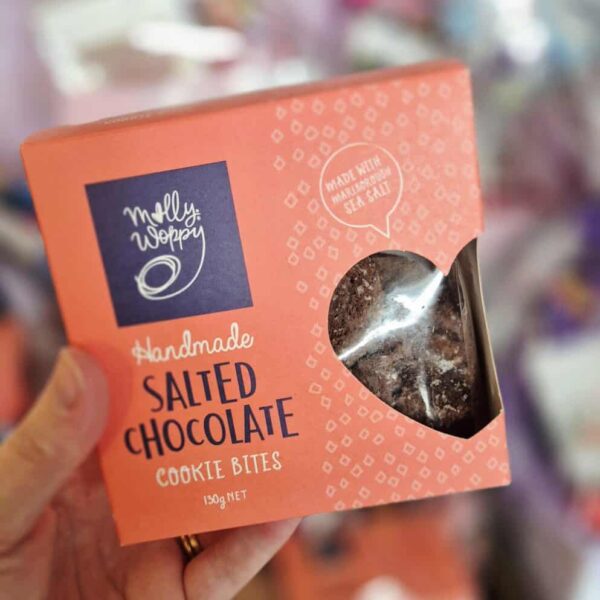 Salted chocolate cookie bites in a pink box with a clear window.