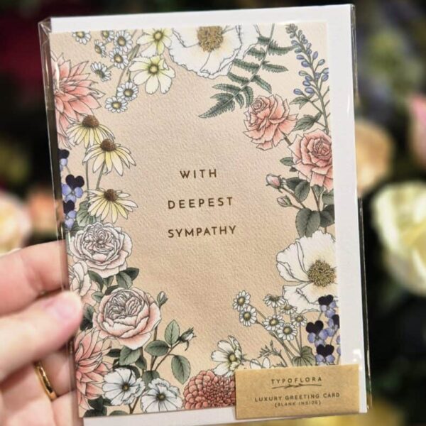 Elegant sympathy card with floral artwork and a message of compassion and support.