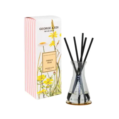 Reed diffuser with French Pear fragrance in a glass vase, accompanied by decorative black reeds.