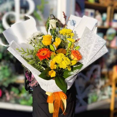 Vibrant spring flower bouquet with yellow, orange, and white blooms, perfect for celebrations and gi.