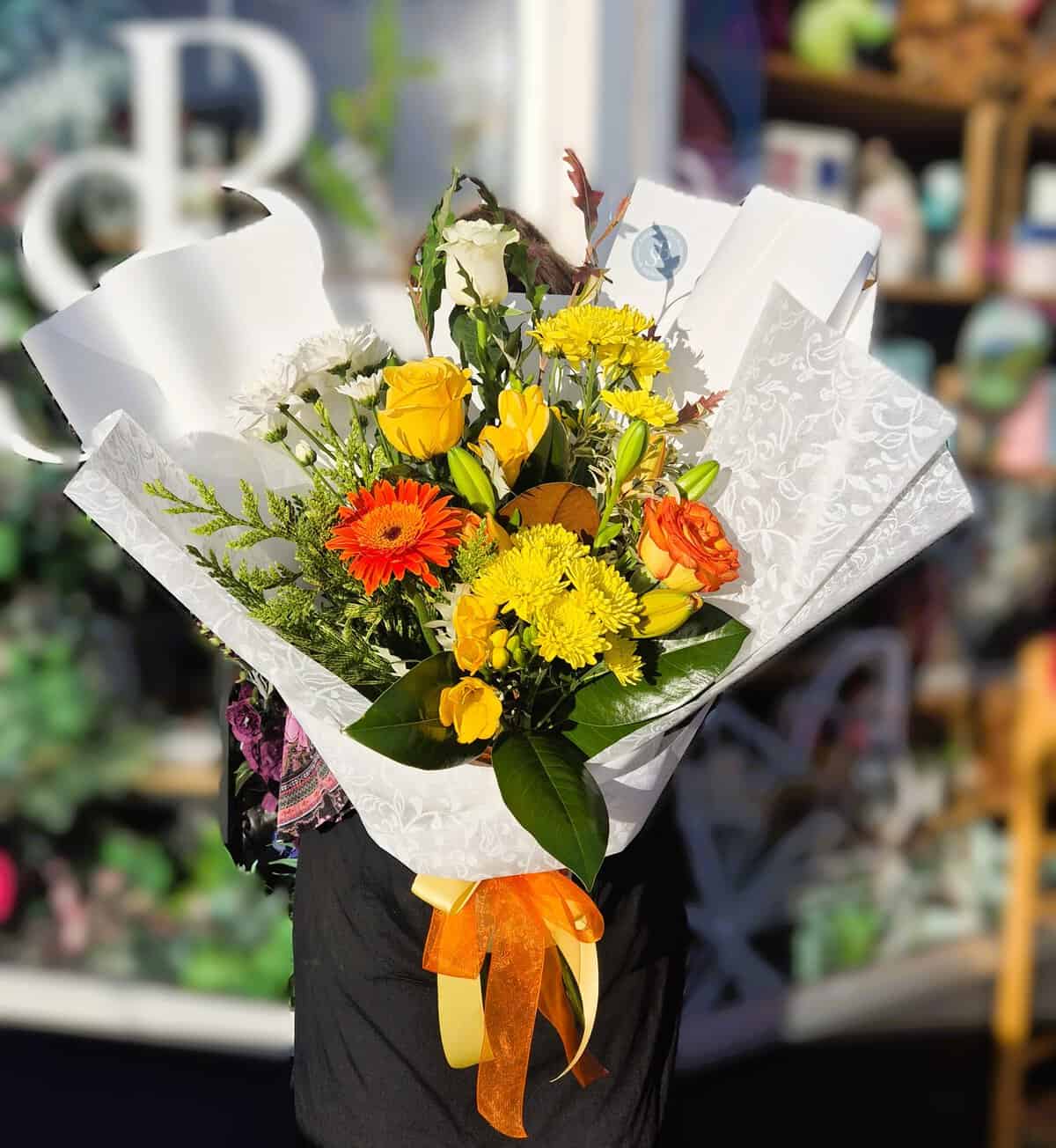 Vibrant spring flower bouquet with yellow, orange, and white blooms, perfect for celebrations and gi.