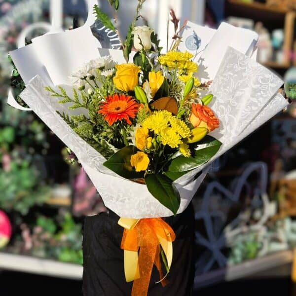 Vibrant mixed flower bouquet with roses, daisies, and greenery, perfect for celebrations and gifting.